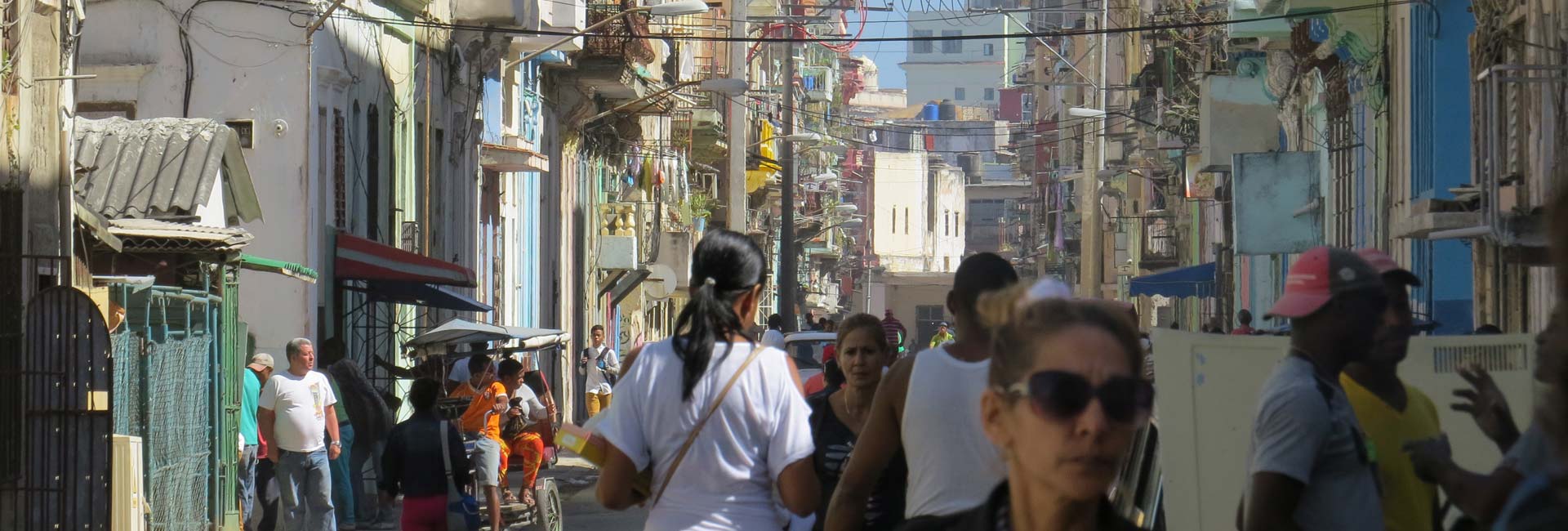 People and vehicles flow through a busy street in downtown Havana in January 2017.